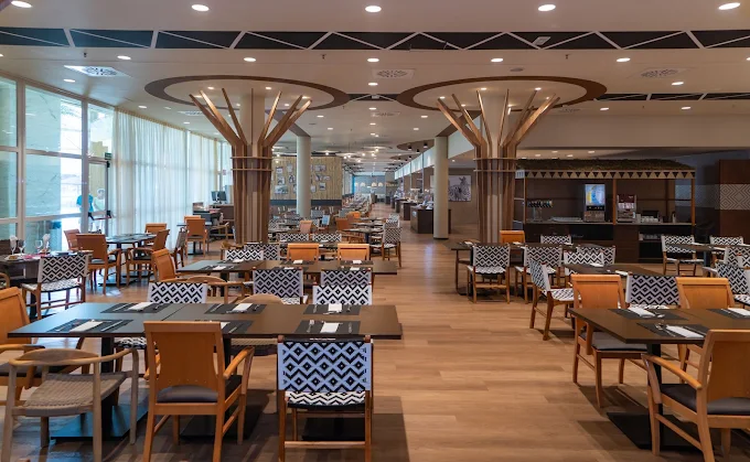 Main buffet restaurant at Flamingo Oasis Benidorm with tree-shaped columns and long dining hall