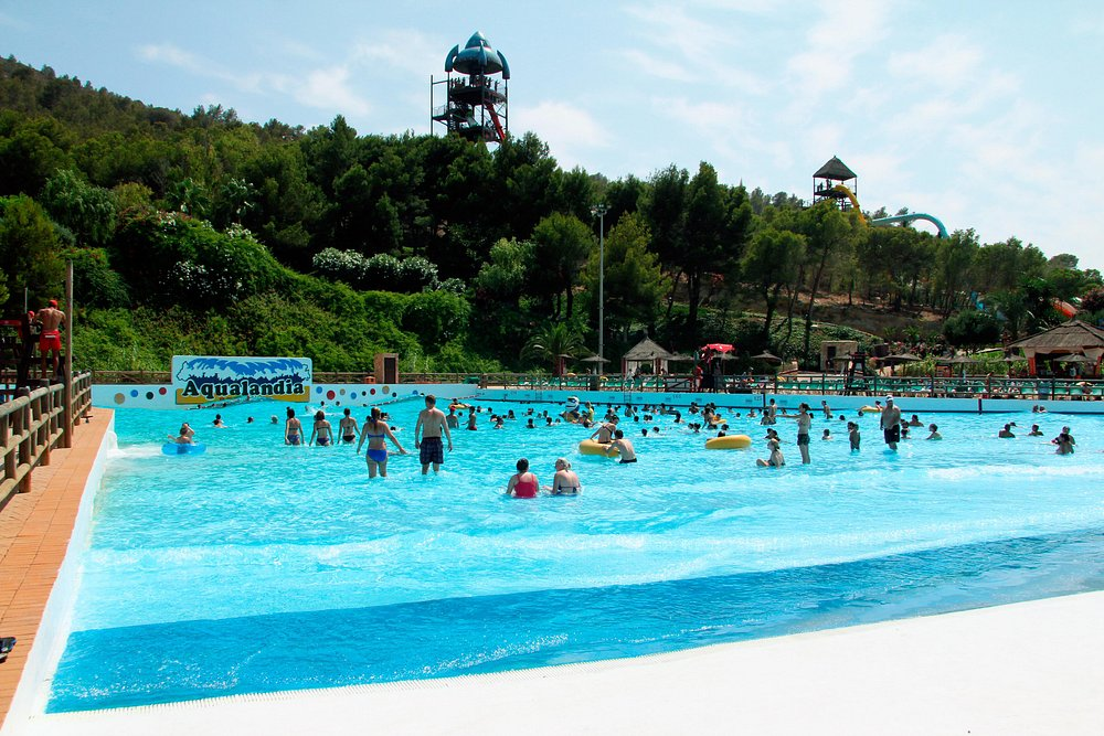 Wave pool at Aqualandia Benidorm Wave pool at Aqualandia Benidorm with swimmers enjoying the large central water area and hillside backdrop