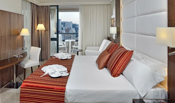 Refurbished twin bedroom at Meliá Benidorm with balcony and city view