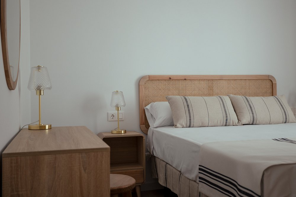 Modern double bedroom with rattan headboard and brass lamps at Magic Pirates Island Resort Benidorm