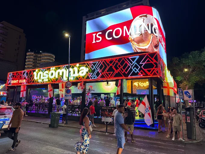 Insomnia Benidorm neon-lit facade at night with LED screen