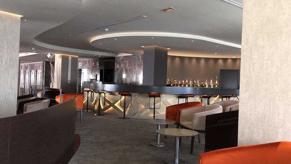 Sky bar lounge with stools and curved bar at Hotel Don Pancho
