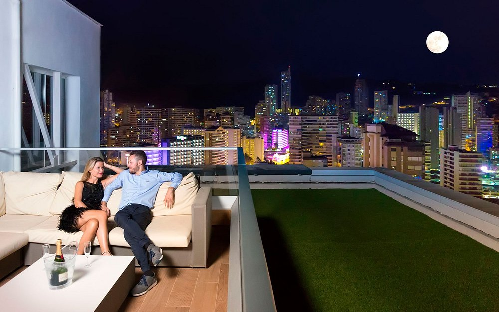 Rooftop terrace at night with Benidorm skyline view at Hotel Don Pancho
