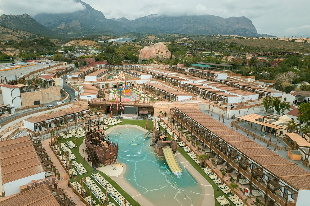 Aerial view of Magic Pirates Island Resort Benidorm with pirate ships, lagoon pool and Sierra Cortina mountains