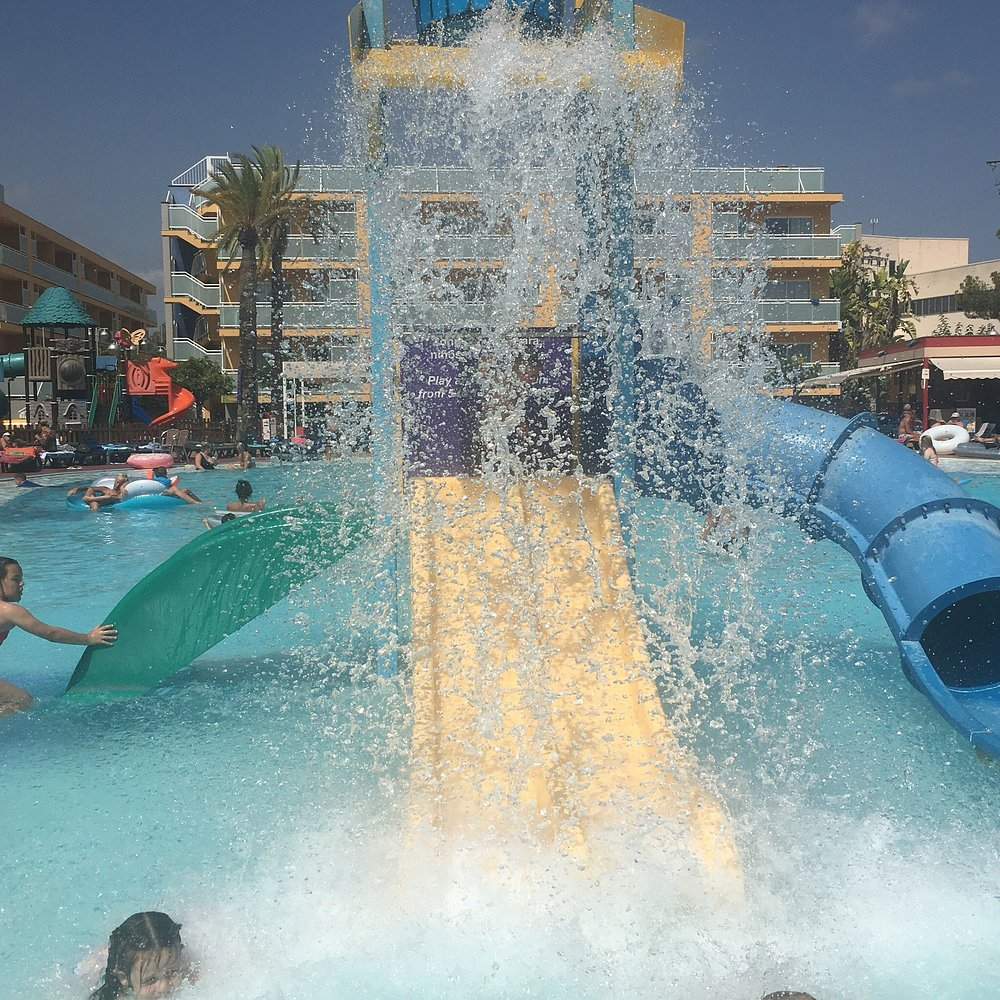 Kids' splash slide tower at Terralta Apartments Benidorm in full action with children playing