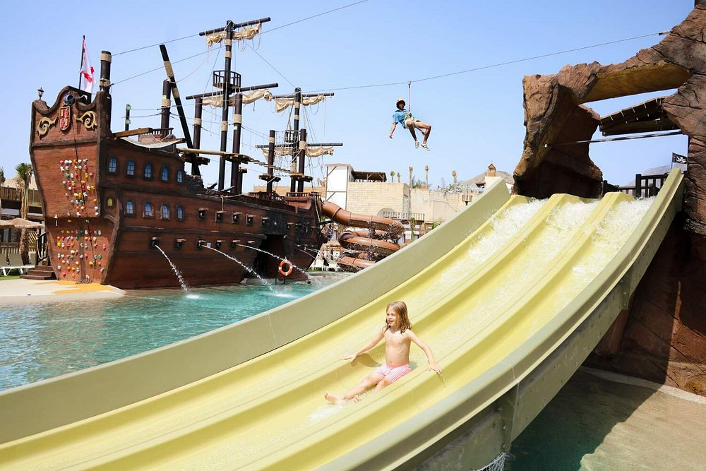 Pirate ship pool with water slide and zip line at Magic Pirates Island Resort